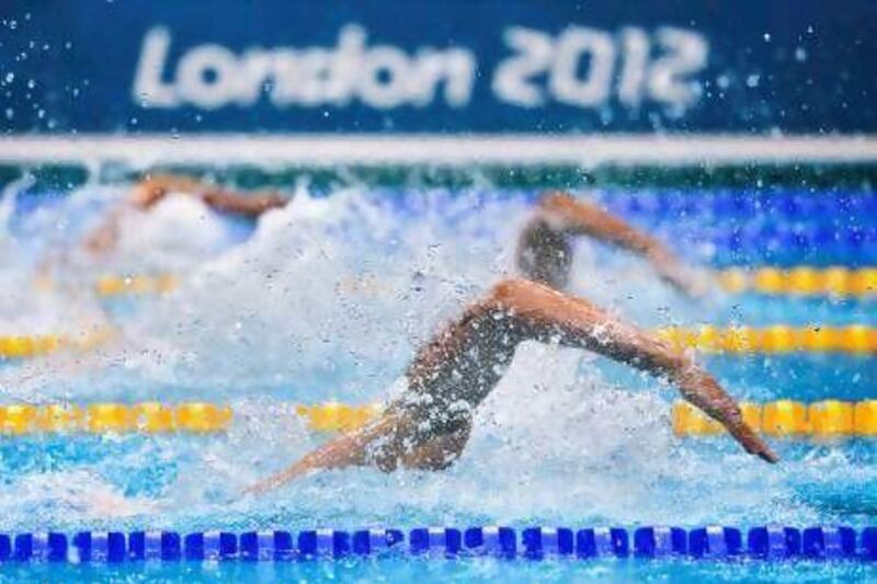 Swimmers in action during the men's 4x100m freestyle relay heats in London yesterday. Fabrice Coffrini / AFP