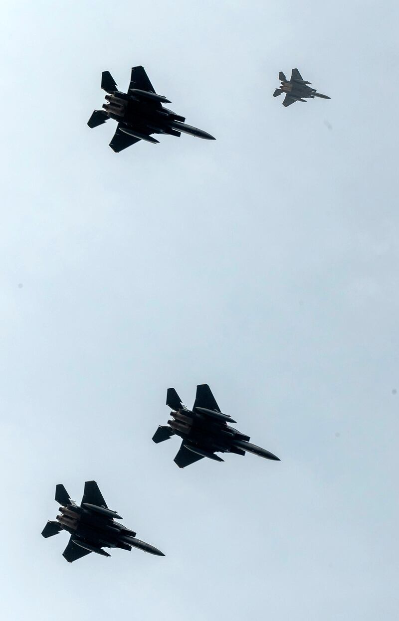 F-15 planes are seen from Endcliffe Park in Sheffield as warplanes from Britain and the United States stage a flypast tribute. PA via AP