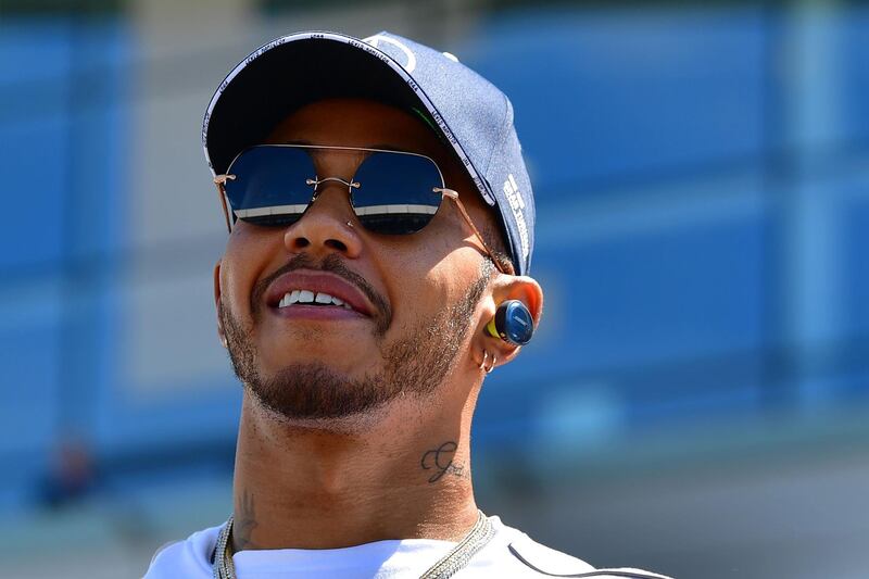 Mercedes' British driver Lewis Hamilton smiles in the pit lane ahead of the British Formula One Grand Prix at the Silverstone motor racing circuit in Silverstone, central England, on July 8, 2018.  / AFP / Andrej ISAKOVIC
