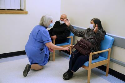 Retired nurse Suzanne Medows speaks to race relations campaigner Dr Hari Shukla, 87, and his wife Ranju before he receives the first of two Pfizer/BioNTech COVID-19 vaccine jabs at the Royal Victoria Infirmary, on the first day of the largest immunisation programme in the British history, in Newcastle, Britain December 8, 2020. Owen Humphreys/Pool via REUTERS