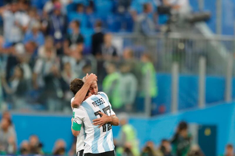 Argentina's Lionel Messi embraces with teammate Javier Mascherano after their 2-1 win over Nigeria during a group D match. Ricardo Mazalan / AP Photo