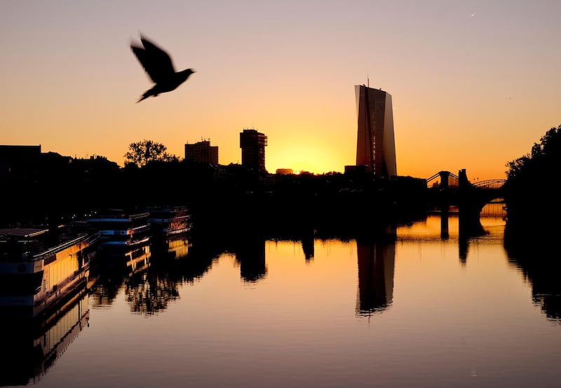 A pigeon flies over the river Main with the European Central Bank in background, right, in Frankfurt, Germany, Wednesday, Sept.12, 2018. The governing council of the ECB will meet on Thursday. (AP Photo/Michael Probst)