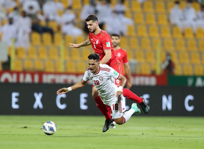 UAE's Abdullah Ramadan is tackled by Saeid Ezatolahi of Iran. Chris Whiteoak / The National