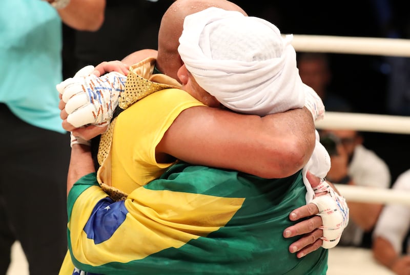 Anderson Silva and Bruno Machado (R) embrace.