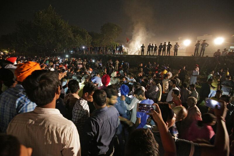 epaselect epa07105165 People and police gather on the site of a train accident in Amritsar, India, 19 October 2018. According to reports, at least 50 people were killed when a train ran over a crowd that was watching the burning of Ravana effigy during Dusshera celebrations.  EPA/RAMINDER PAL SINGH