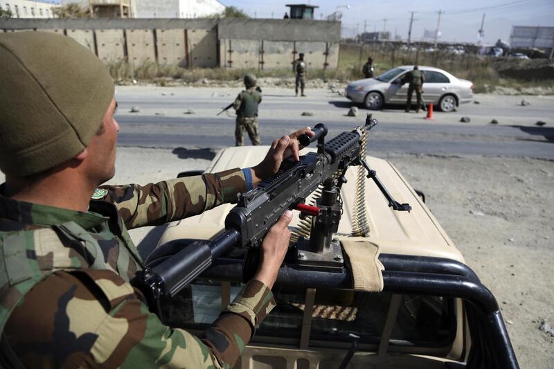 Army soldiers search a car at a checkpoint in Kabul. AP Photo