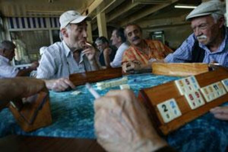 Retired men play Okey and smoke in Mutlu Tea House at Kasimpasa, a working-class district of Istanbul.