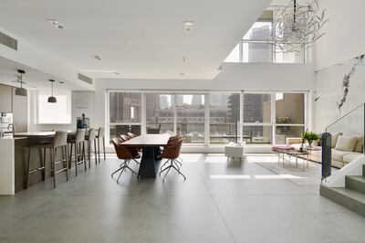 The large open plan living room, dining area and modern kitchen on the ground floor. Photo: Luxhabitat Sotheby's International Realty