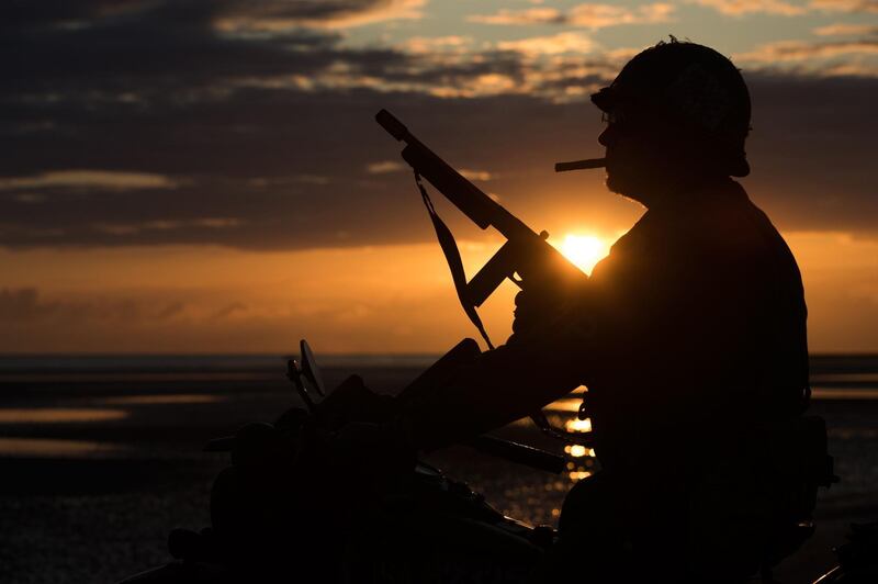 The silhouette of a WWII enthusiast sitting, as the sun rises, on a period motorcycle on the beach of Asnelles, in Normandy, during the D-Day commemorations marking the 75th anniversary of the World War II Allied landings in Normandy. AFP