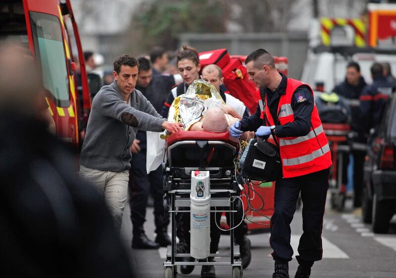 One of the casualties of the terror attacks in Paris last week is transported by ambulance. Photo: Thibault Camus / AP