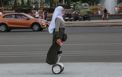 Kyrgyz woman rides a segway in downtown of Bishkek, Kyrgyzstan, 09 August 2021. EPA
