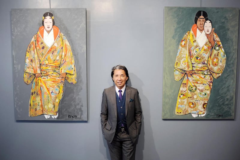 Fashion designer Kenzo Takada, aka Kenzo, posing near some of his self-portrait paintings in Paris on June 16, 2010. AFP