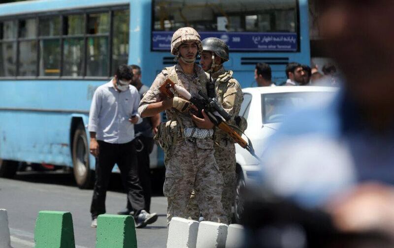 Iranian soldiers stand near parliament building during an attack in Tehran. Hossein Mersadi / EPA