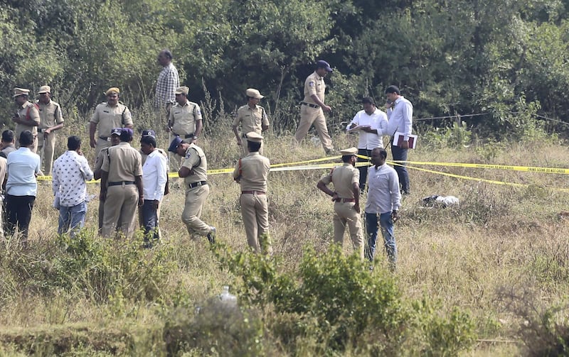 Indian police officials secure the area where four men suspected of raping and killing a woman were killed in Shadnagar some 50 kilometers or 31 miles from Hyderabad, India, Friday, Dec. 6, 2019. Indian police on Friday fatally shot and killed four men suspected of raping and killing a woman in southern India, leading some to celebrate their deaths as justice in a case that has sparked protests across the country. (AP Photo/Mahesh Kumar A.)