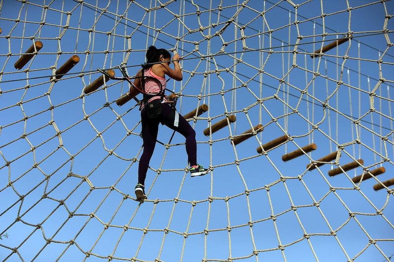 The National’s reporter, Afshan Ahmed, tests out the rope and zipline obstacles at the Aventura nature adventure park, at Mushrif Park in Dubai. Satish Kumar / The National 