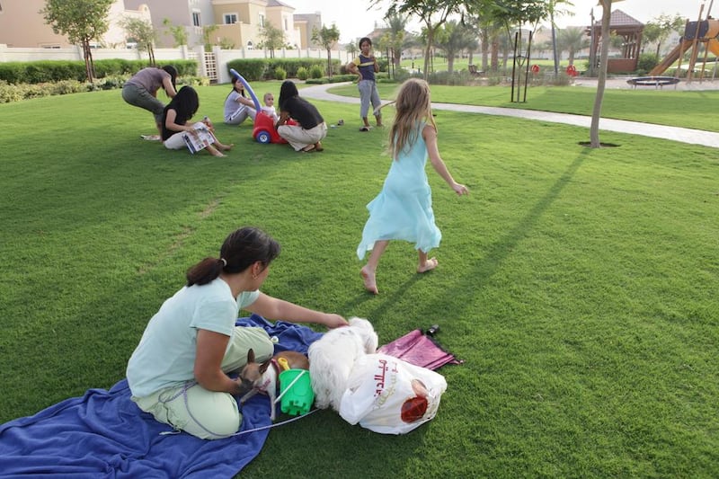 A nanny looks after a girl as she plays in a park in Dubai. In the Gulf, the low cost of labour and the financial need for both parents to work full-time mean live-in maids and nannies are very common. Jaime Puebla  / The National