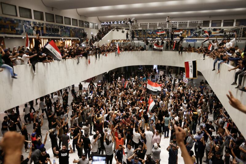 Mr Al Sadr's supporters protest against corruption inside the Parliament building in Baghdad. Reuters