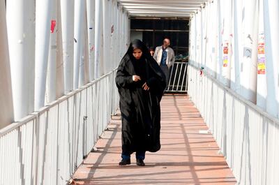 An Iranian woman wearing a chador walks down a street in the capital Tehran on February 7, 2018.
A spate of unprecedented protests against Iran's mandatory headscarves for women have been tiny in number, but have still reignited a debate that has preoccupied the Islamic republic since its founding. / AFP PHOTO / ATTA KENARE