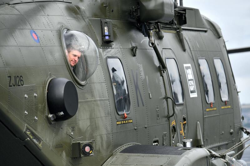 PORTSMOUTH, ENGLAND - AUGUST 16: A man looks from the window of a helicopter as Britain's Prime Minister Theresa May (unseen) tours the 65,000-tonne British aircraft carrier HMS Queen Elizabeth after it arrived at Portsmouth Naval base, its new home port on August 16, 2017 in Portsmouth, England. The HMS Queen Elizabeth is the lead ship in the new Queen Elizabeth class of supercarriers. Weighing in at 65,000 tonnes she is the largest war ship deployed by the British Royal Navy. She is planned to be in service by 2020 and with a second ship, HMS Prince of Wales, to follow.  (Photo by Ben Stansall - WPA Pool/Getty Images)