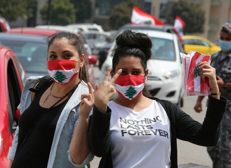 Anti-government demonstrators wearing face masks gesture as they pose during a protest, amid a countrywide lockdown to combat the spread of the coronavirus disease. Reuters