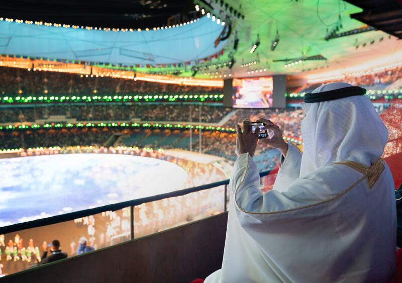 Sheikh Mohamed bin Zayed, then Crown Prince of Abu Dhabi and Deputy Supreme Commander of the Armed Forces, takes a photograph during the opening ceremony of the 2022 Beijing Winter Olympics, at the National Stadium in China's capital. All Photos: Oussama Lacfer for the Ministry of Presidential Affairs