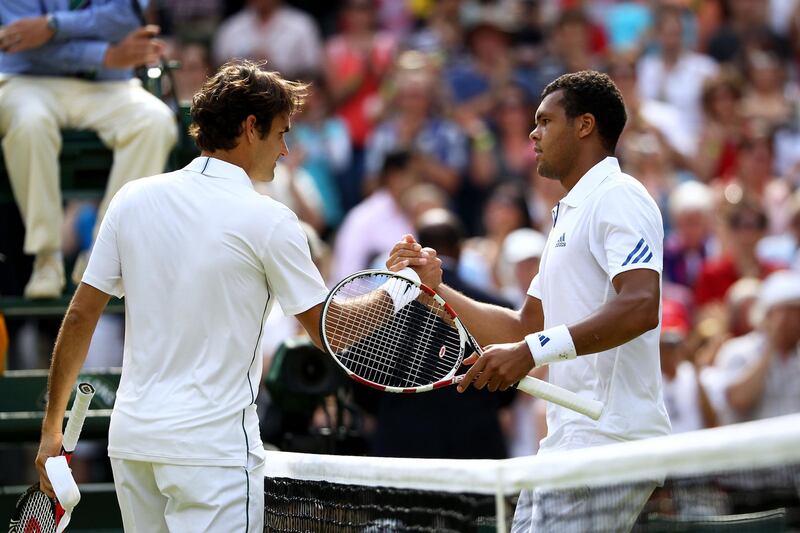 LONDON, ENGLAND - JUNE 29:  Jo-Wilfried Tsonga (R) of France shakes hands with Roger Federer of Switzerland after winning his quarterfinal round match on Day Nine of the Wimbledon Lawn Tennis Championships at the All England Lawn Tennis and Croquet Club on June 29, 2011 in London, England.  (Photo by Julian Finney/Getty Images)