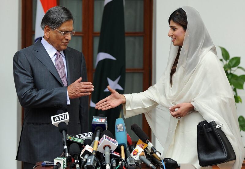 Pakistan Foreign Minister Hina Rabbani Khar (R) shakes hands with Indian Foreign Minister S. M. Krishna (L) prior to a meeting in New Delhi on July 27, 2011. India and Pakistan's foreign ministers were set to hold their first talks in a year, looking to breathe fresh life into a peace process still stifled by the trauma of the 2008 Mumbai attacks. India suspended contacts with its arch-rival after the attacks and their peace dialogue has struggled to gain any real traction since its formal resumption earlier this year in an atmosphere of mutual recrimination and mistrust. AFP PHOTO/Prakash SINGH

