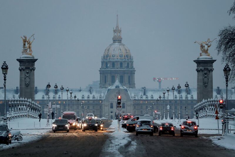 The traffic on the snow-covered Pont Alexandre III bridge near the Invalides in the early morning in Paris, as winter weather with snow and freezing temperatures arrive in France. Gonzalo Fuentes / Reuters