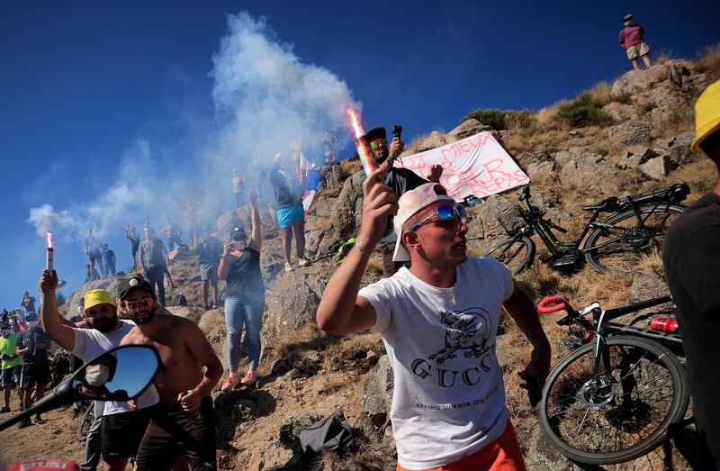 Spectators light flares during Stage 6. EPA