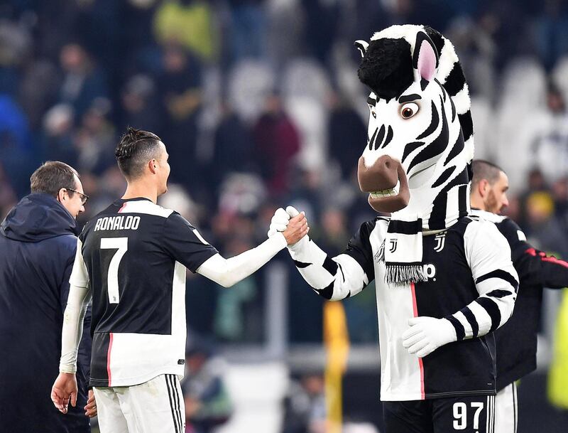 Cristiano Ronaldo celebrates with Juventus mascot J the zebra. AFP