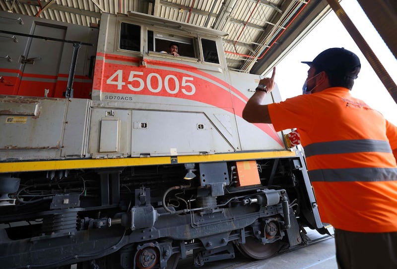 Engineers work on an Etihad Rail train at Al Mirfa. While freight is the immediate priority, passenger transport is also a key focus. Photo: AFP