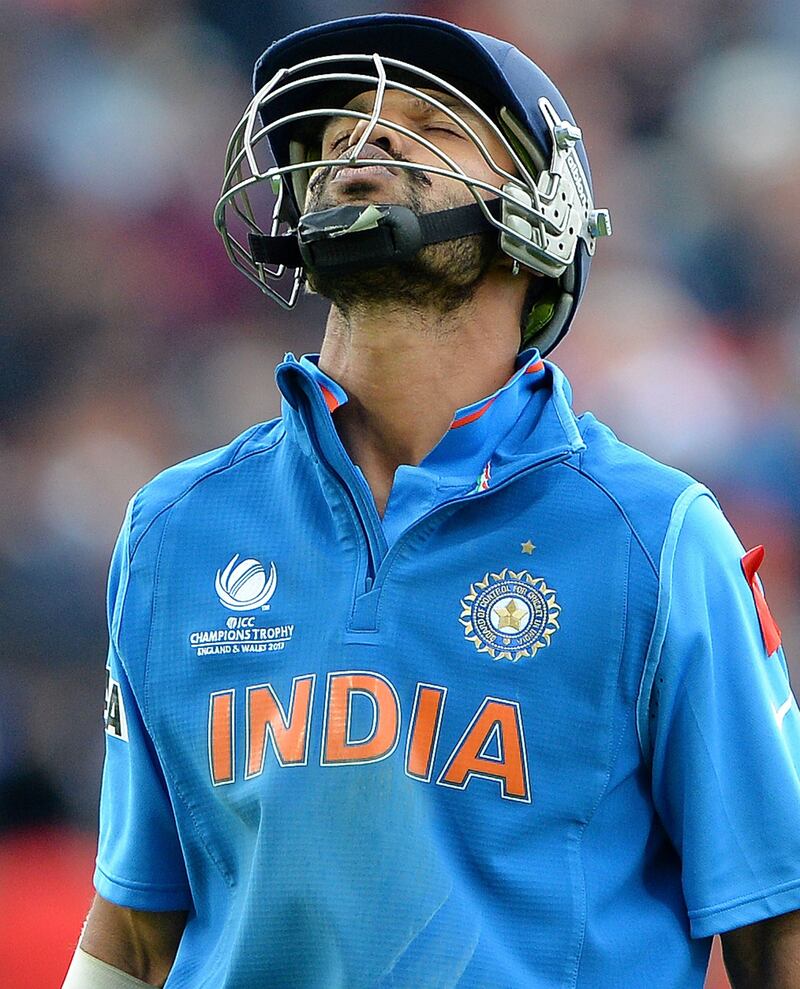 India's Shikhar Dhawan reacts after losing his wicket during the 2013 ICC Champions Trophy Final cricket match between England and India at Edgbaston in Birmingham, central England on 23, June 2013.  Play in the rain-marred Champions Trophy final between hosts England and world champions India at Edgbaston got underway nearly six hours late. Rain reduced the showpiece match from a 50 overs per side contest to the bare minimum of 20 overs per side required to produced a result, with the fixture, due to get underway at 10.30am local time (0930GMT) finally starting at 4:20pm. AFP PHOTO/ANDREW YATES
 RESTRICTED TO EDITORIAL USE
 *** Local Caption ***  408200-01-08.jpg