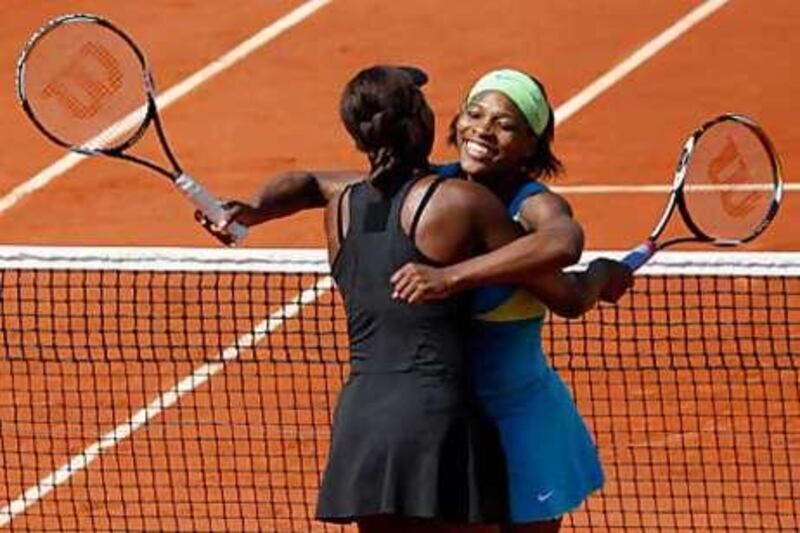 The Williams sisters hug after winning the doubles final.