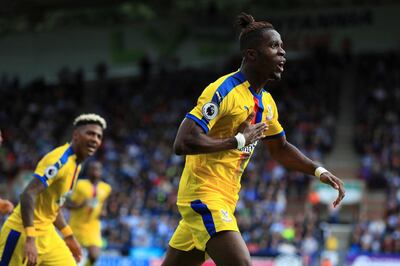 Crystal Palace's Wilfried Zaha celebrates scoring his side's first goal of the game during the English Premier League soccer match between Huddersfield and Crystal Palace, at the Kirklees Stadium, in Huddersfield, England, Saturday Sept. 15, 2018. (Mike Egerton/PA via AP)