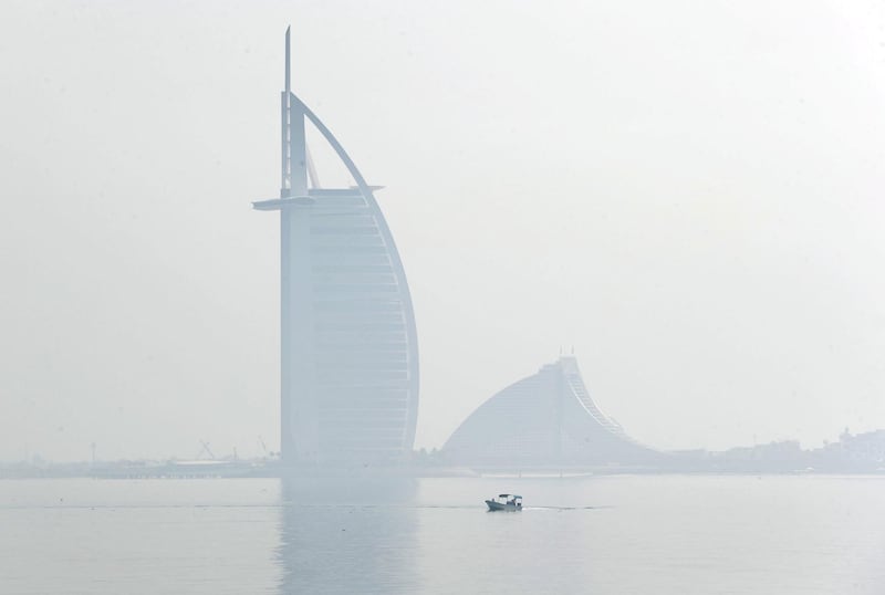 Dubai, United Arab Emirates - Reporter: N/A: Weather. Fog and mist cover the Burj Al Arab as a boat goes passed. Wednesday, April 8th, 2020. Dubai. Chris Whiteoak / The National