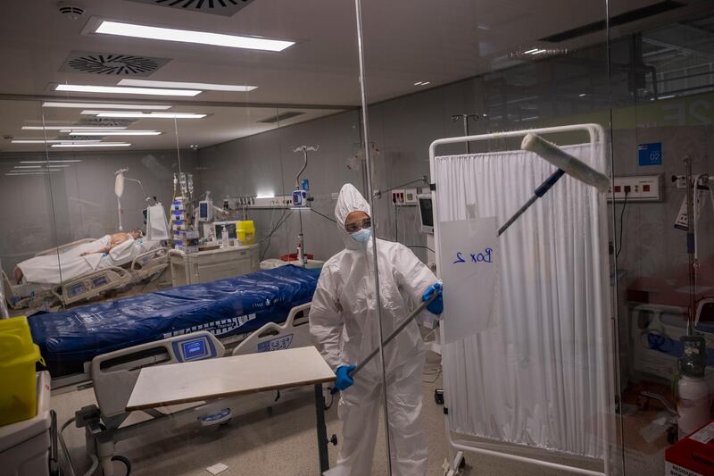 An employee of the new Nurse Isabel Zendal Hospital disinfects the Covid-19 ICU ward in Madrid, Spain. AP Photo