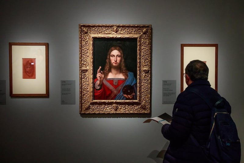 A visitor looks at the painting entitled 'Salvator Mundi' by Italian Renaissance artist Leonardo Da Vinci's workshop during an exhibition at the Louvre Museum in Paris, France.  EPA