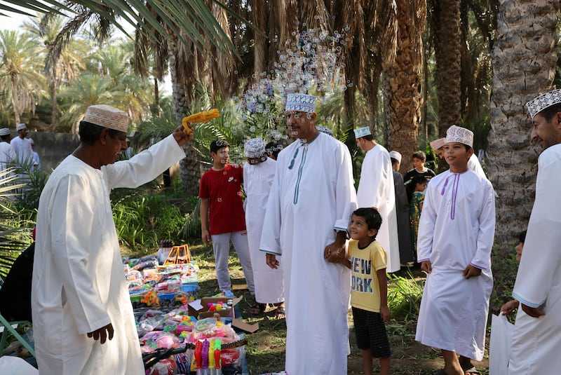 Omanis gather as goods are sold in preparation for the Eid al-Fitr holiday at Surur area in Oman's governorate of Samail, about 80 ks southwest of Muscat on April 28, 2022. AFP