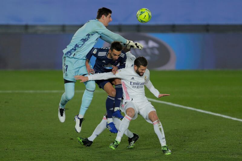 Real Madrid goalkeeper Thibaut Courtois attempts to punch clear. AP