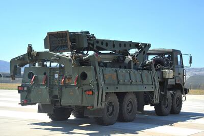 FILE - In this Tuesday, Aug. 27, 2019 file photo, a truck carrying parts of the S-400 air defense systems, exits a Russian transport aircraft after landing at Murted military airport outside Ankara, Turkey. NATO-member Turkey has tested its Russian-made advanced air defense missile system, Turkish media reports said Friday, Oct. 16, 2020, raising the specter of a new standoff with the United States. (Turkish Defence Ministry via AP, Pool, File)