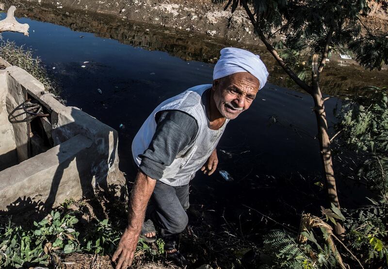 Egyptian farmer Mohamed Omar, 65, supplies his farmland with water from a canal, fed by the Nile river, in the village of Baharmis on the outskirts of Egypt's Giza province, northwest of the capital Cairo, on December 1, 2019. - Egypt has for years been suffering from a severe water crisis that is largely blamed on population growth. Mounting anxiety has gripped the already-strained farmers as the completion of Ethiopia's gigantic dam on the Blue Nile, a key tributary of the Nile, draws nearer. Egypt views the hydro-electric barrage as an existential threat that could severely reduce its water supply. But Ethiopia insists that Egypt's water share will not be affected. (Photo by Khaled DESOUKI / AFP)