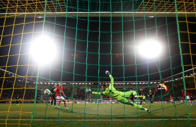 United's David De Gea dives to save the ball. Getty