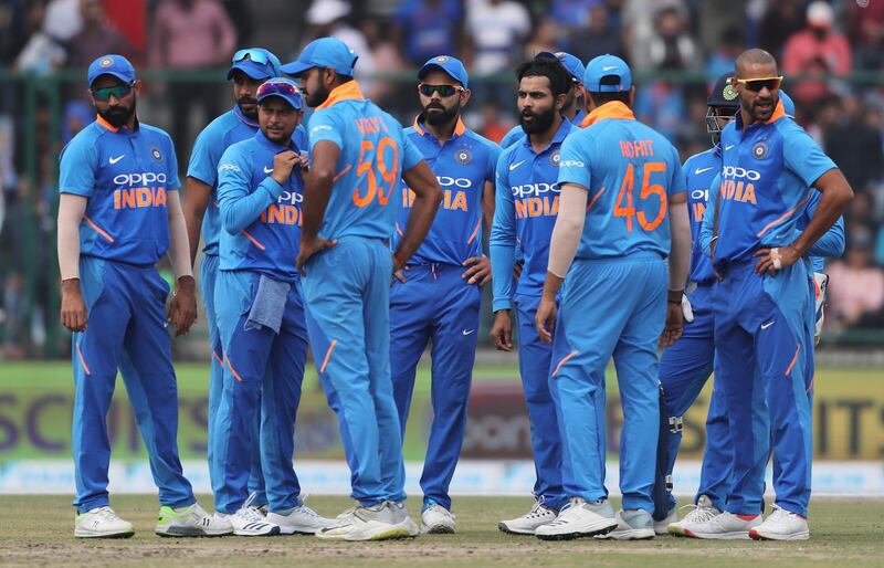 Indian cricketers watch the replay of the dismissal of Australia's captain Aaron Finch on a giant screen during the final one day international cricket match between India and Australia in New Delhi, India, Wednesday, March 13, 2019. (AP Photo/Altaf Qadri)