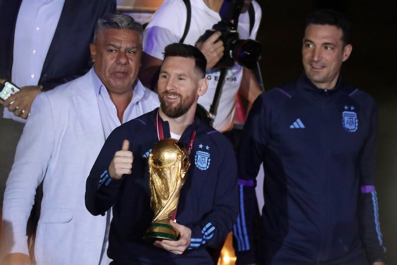 Lionel Messi with the World Cup trophy after arriving at Ezeiza International Airport on Tuesday, December 20, 2022. AFP