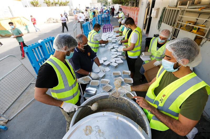 Volunteers from Adliya Charity prepare meals for free distribution among the public during the month of Ramadan, in Manama, Bahrain. Reuters