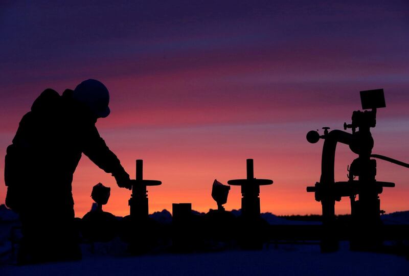 FILE PHOTO: A worker checks the valve of an oil pipe at an oil field owned by Russian state-owned oil producer Bashneft near the village of Nikolo-Berezovka, northwest of Ufa, Bashkortostan, Russia January 28, 2015. REUTERS/Sergei Karpukhin/File Photo