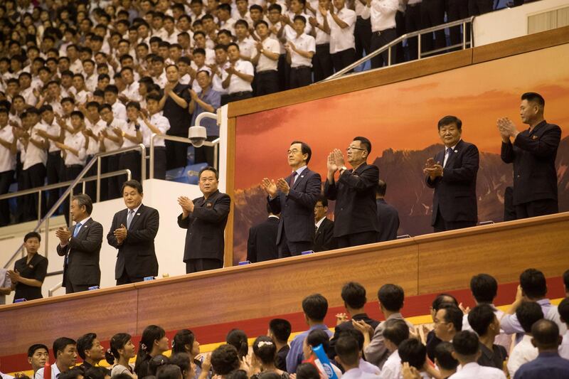 Ri Son Gwon, chairman of the Committee for the Peaceful Reunification of the Country, and South Korean Unification Minister Cho Myoung-gyon watch the clash. Reuters