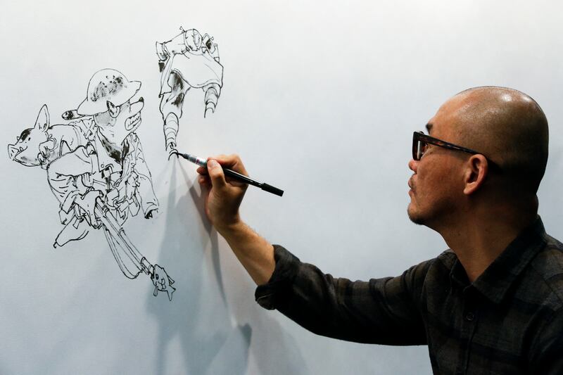 South Korean comic artist Kim Jung Gi draws during the 35th Comic Fair 2017 in Barcelona on March 30, 2017. AFP