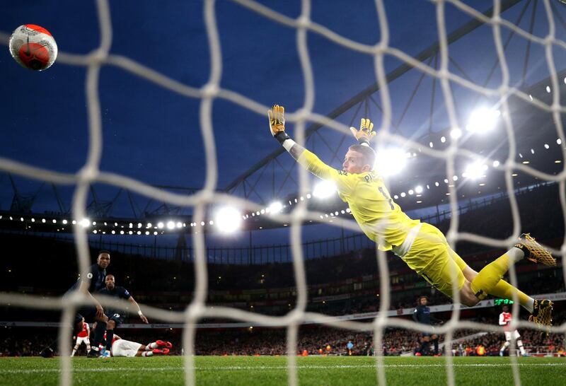 Pierre-Emerick Aubameyang scores Arsenal's third goal past Jordan Pickford of Everton. Getty Images