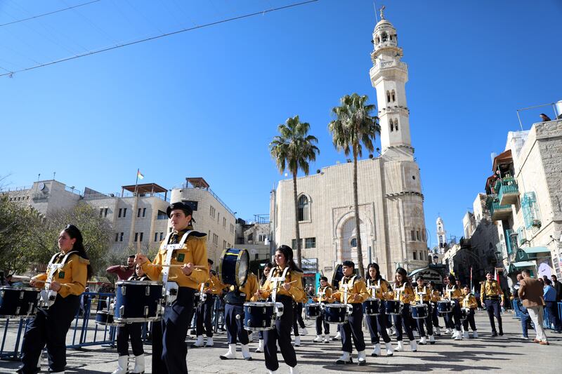 Members of a Palestinian band march through the square. EPA